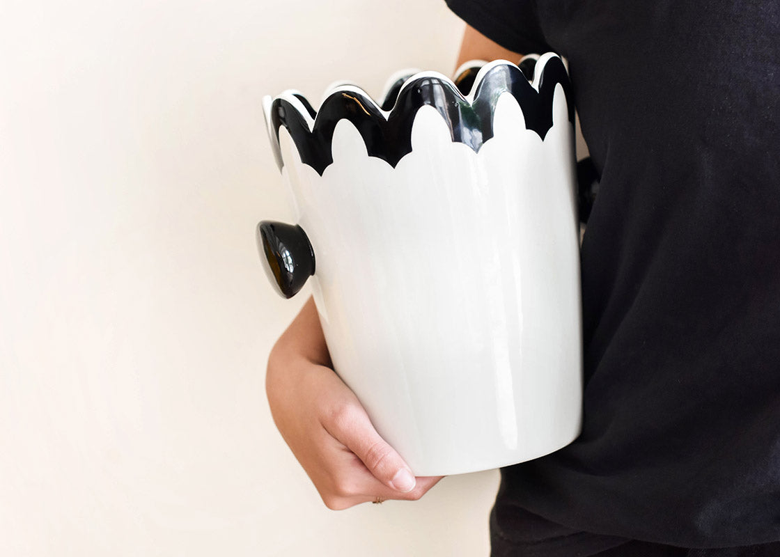 Front View of Woman in Black Clutching Black Arabesque Scallop Ice Bucket at Her Side