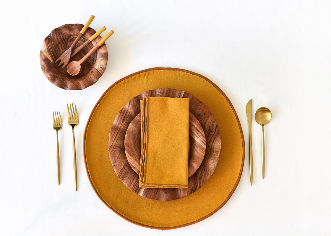Overhead View of Place Setting with Coordinated Fundamentals set on Brass Color Block Round Placemat