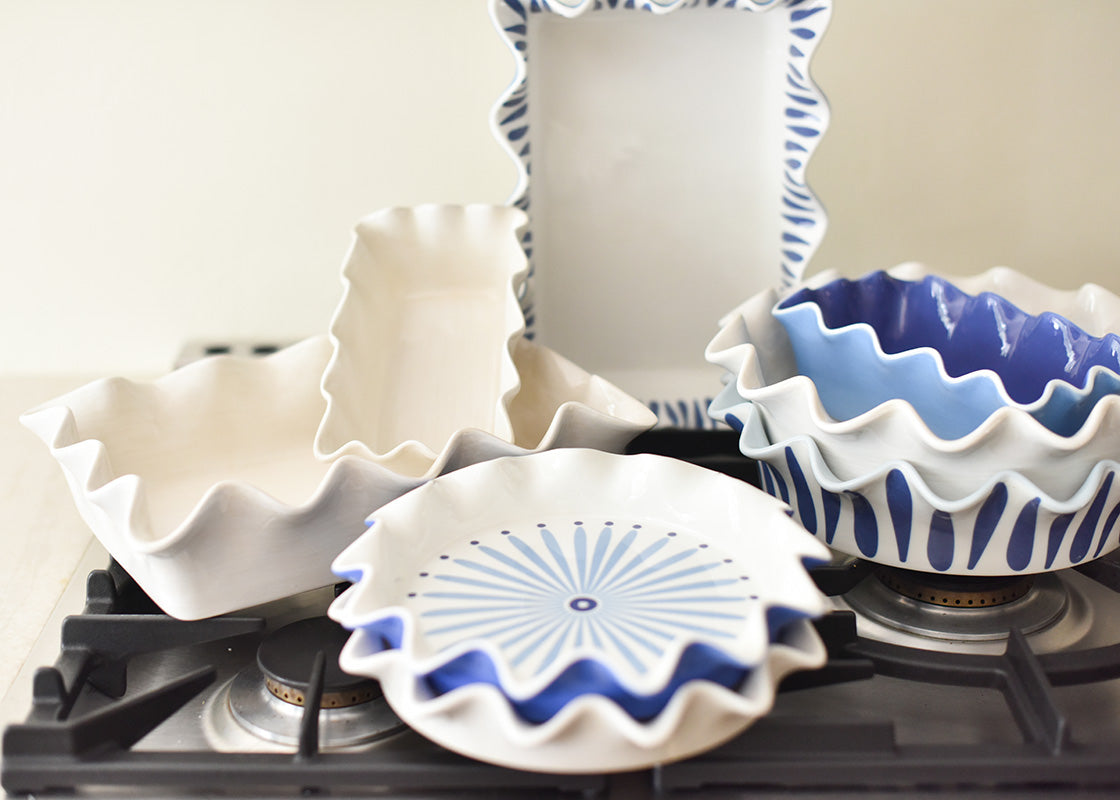 Front View of Stacks of Ruffled Bakeware on Stovetop