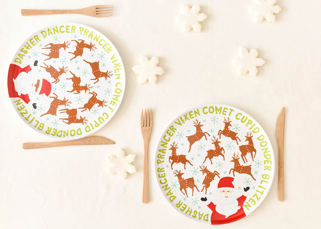 Overhead View of Two Place Settings Including Brown Skin Calling All Reindeer Melamine Dinner Plate