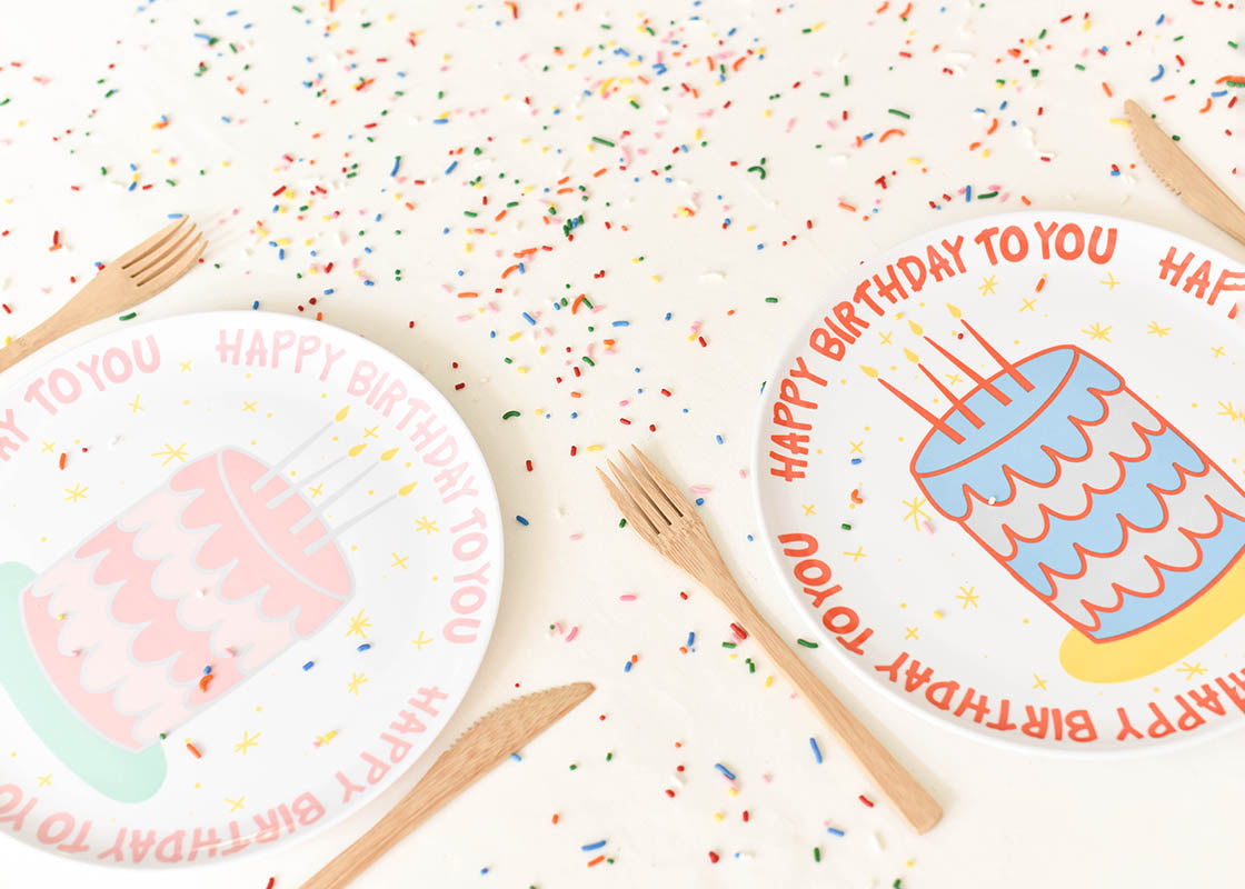Cropped Close up of Two Place Settings Including Pink Happy Birthday Cake Melamine Dinner Plate