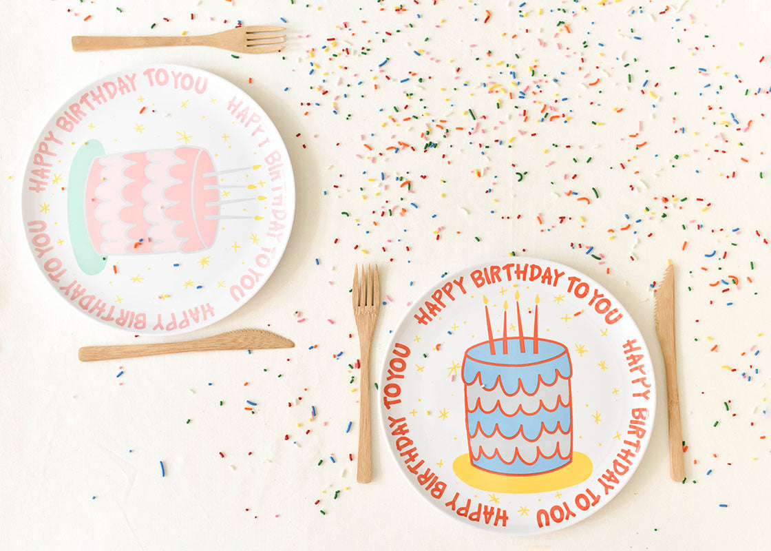 Overhead View of Two Place Settings Including Pink Happy Birthday Cake Melamine Dinner Plate