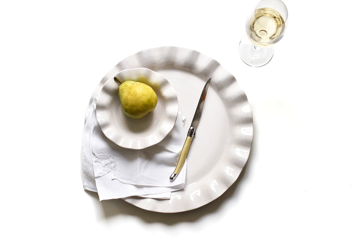 Overhead View of Simple and Stylish Place Setting Using Large Signature White Ruffle Round Platter
