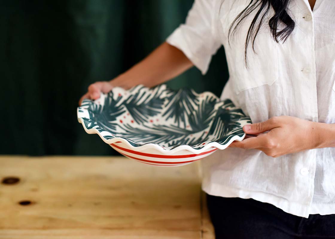 Front View of Woman Holding Balsam and Berry Ruffle Best Bowl to one Side with Both Hands
