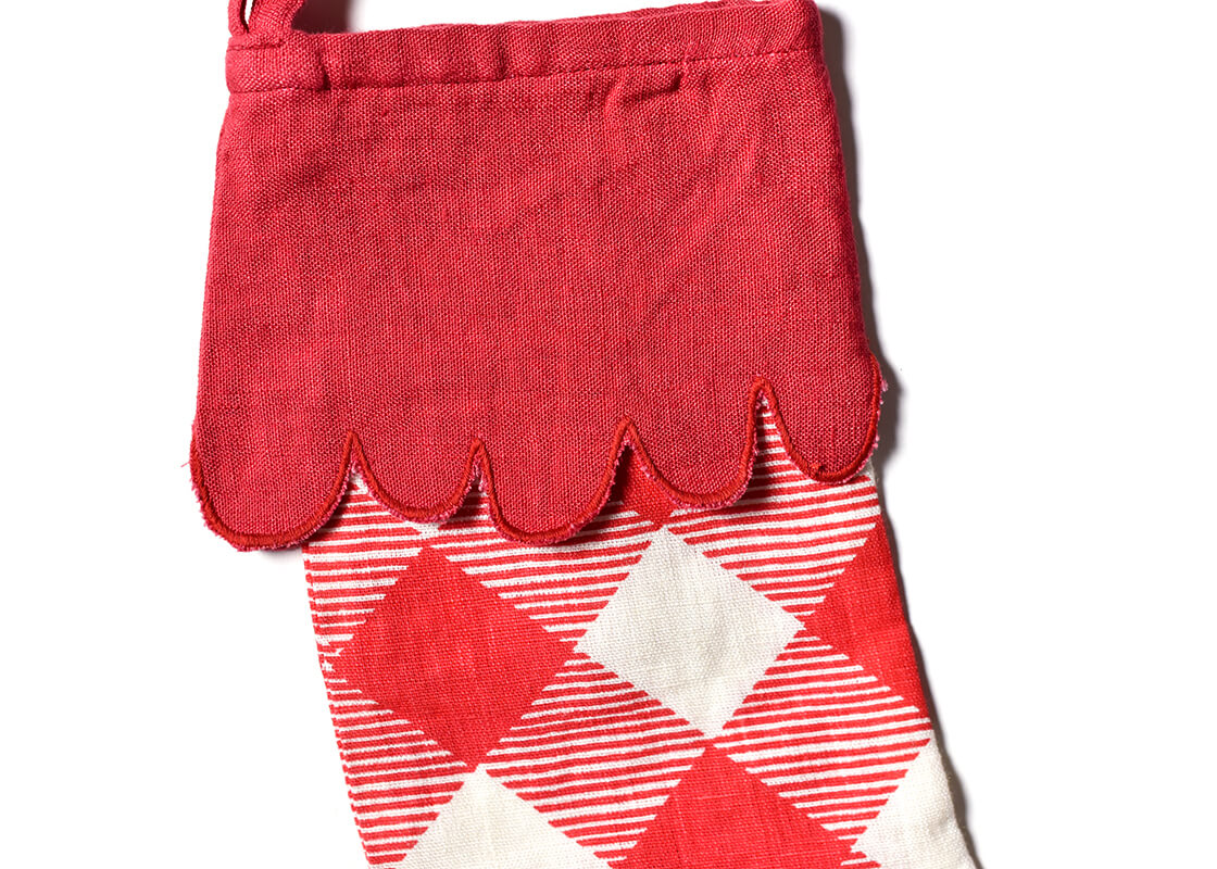 Front View of Red Plaid Buffalo Stocking with Trim Paired with Christmas Stockings of Other Designs