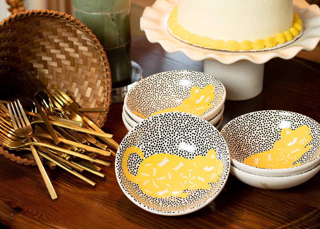 Front View of Stacks of Bowls and Cake on Cake Stand Including Chinese Zodiac Bowl with Rat Design