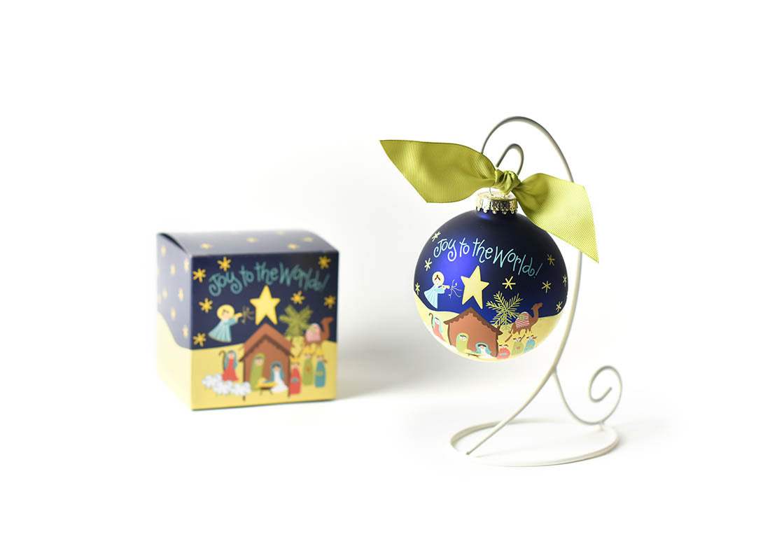 Front View of Joy to the World Nativity Glass Ornament Placed on White Display Stand with Matching Box