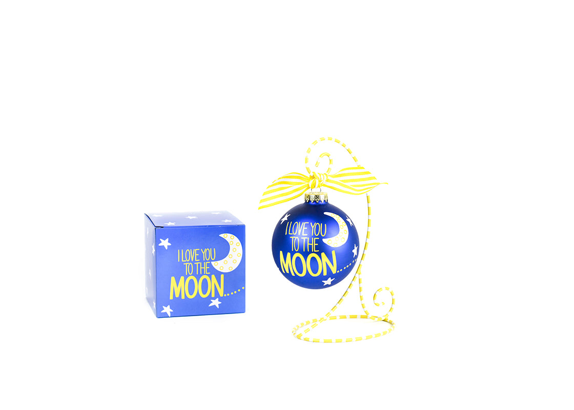 Front View of I Love You to the Moon and Back Glass Ornament Placed on Navy and White Stripe Display Stand and Matching Box
