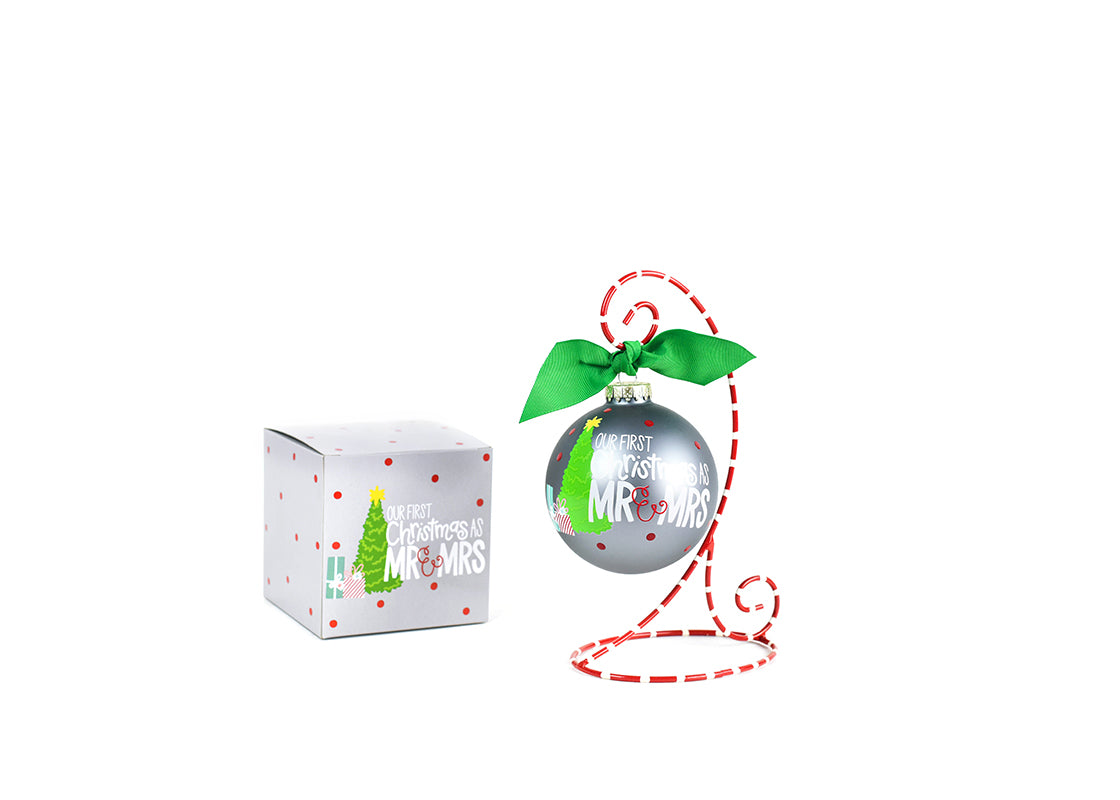 Front View of Our First Christmas as Mr. & Mrs. Glass Ornament Placed on Red and White Stripe Display Stand with Matching Box