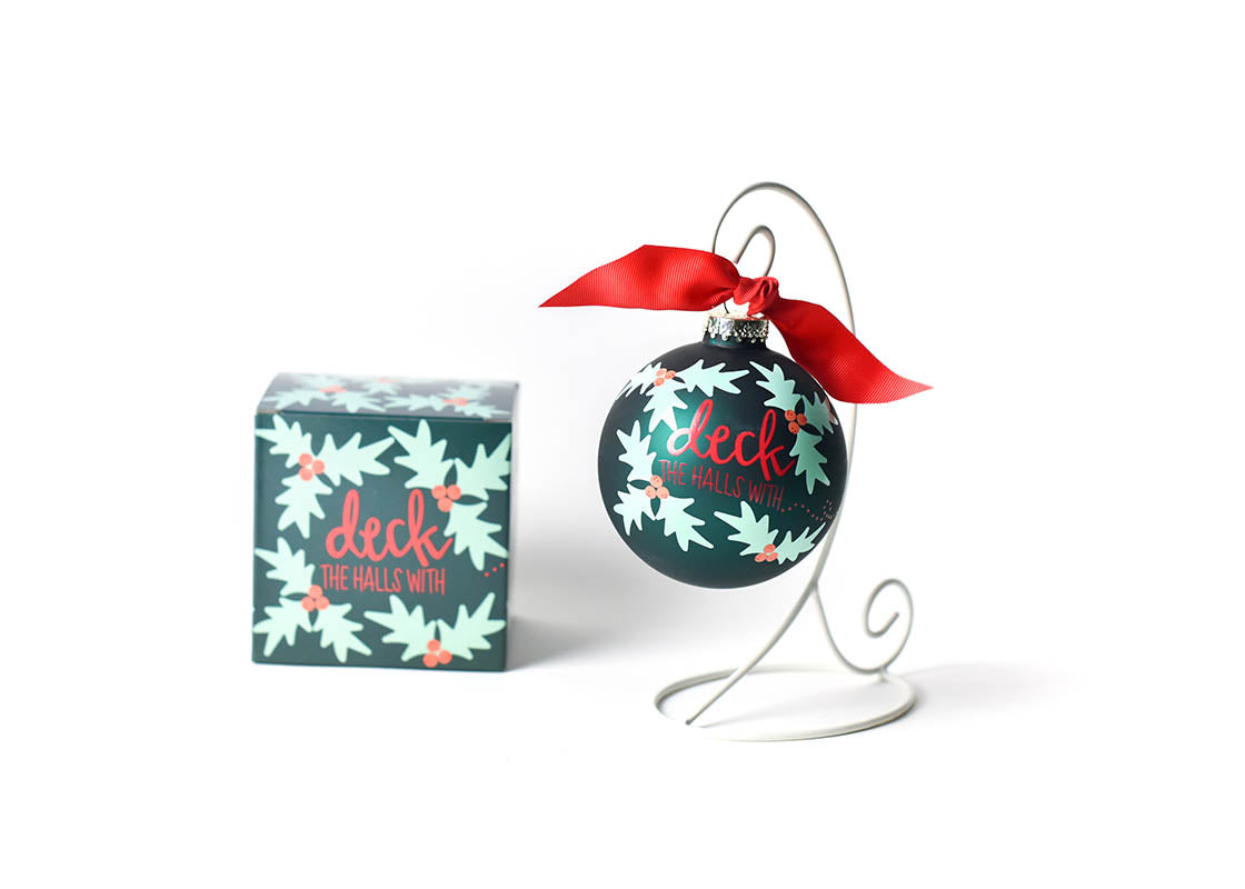 Front View of Boughs of Holly Glass Ornament Placed on White Display Stand with Matching Box