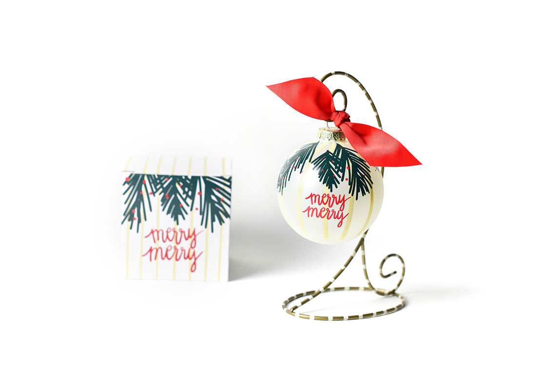 Front View of Balsam Merry Merry Glass Ornament Placed on Gold and White Ornament Stripe Display Stand with Matching Box