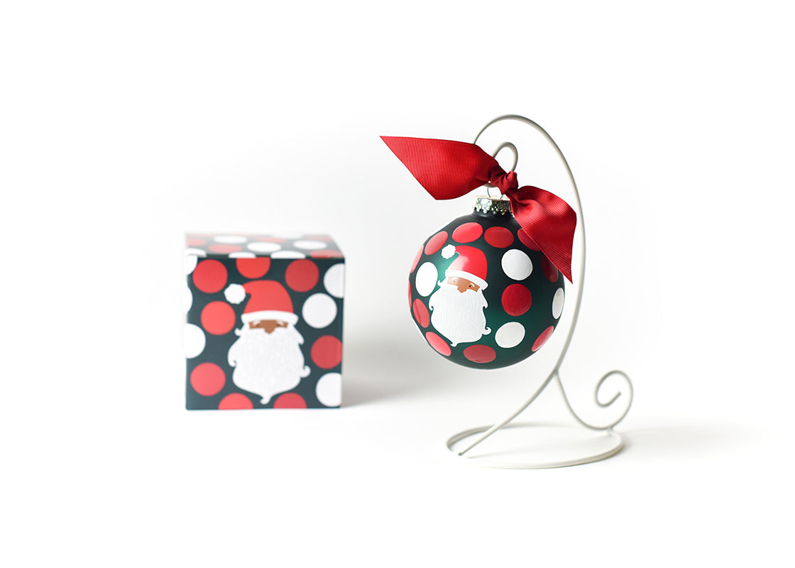 Front View of Brown Skin Ho Ho Santa Glass Ornament Placed on White Display Stand with Matching Box