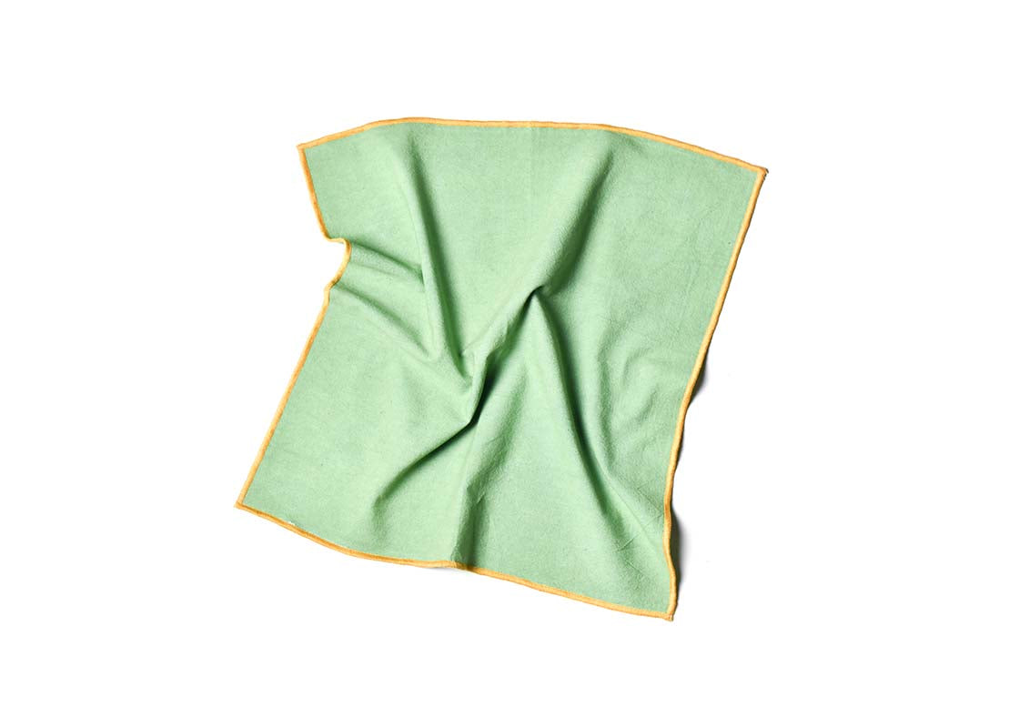 Overhead View of Crumpled Napkin Sage and Brass Color Block Napkin Showcasing Texture and Personality