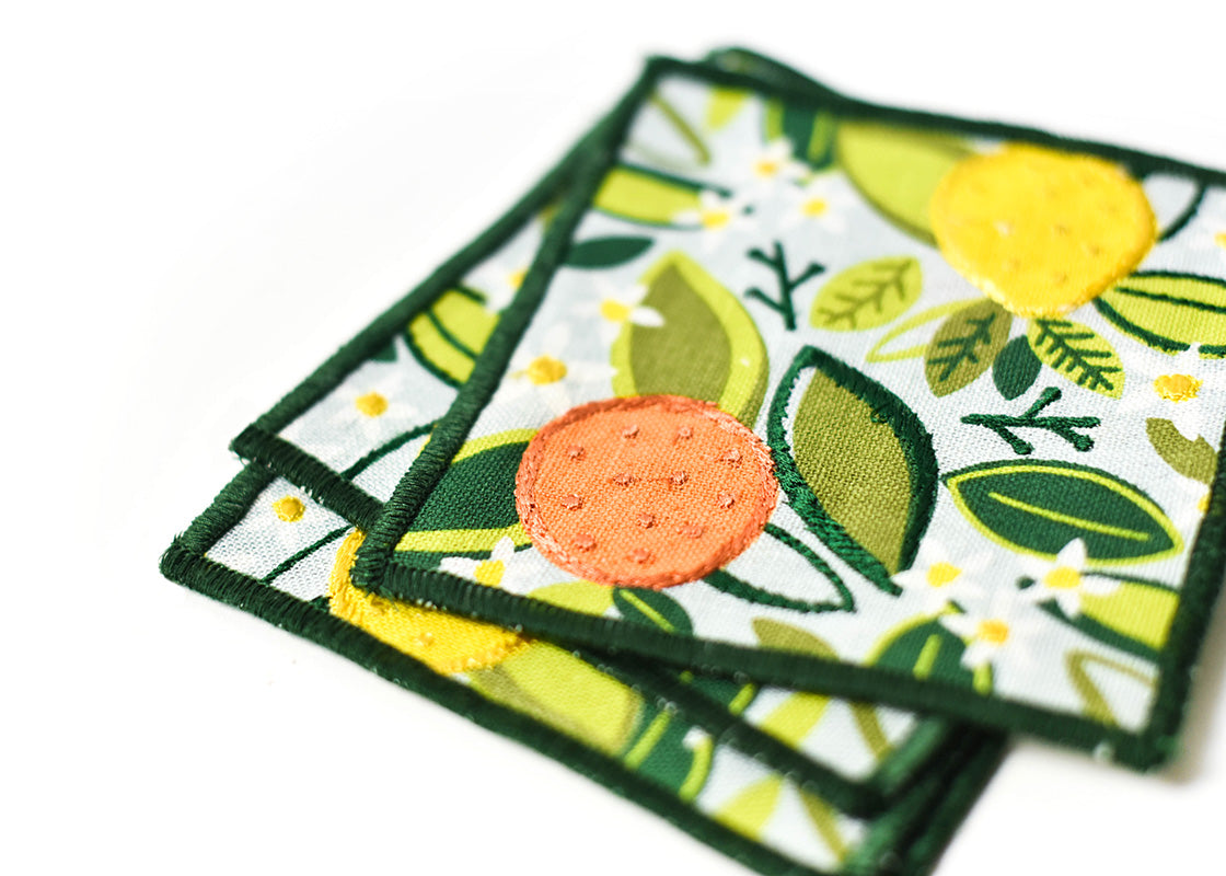 Cropped Close up of Embroidery on Loosely Stacked Blue Citrus Print Cocktail Napkins Set of 4 Showing Pretty Fabric Texture