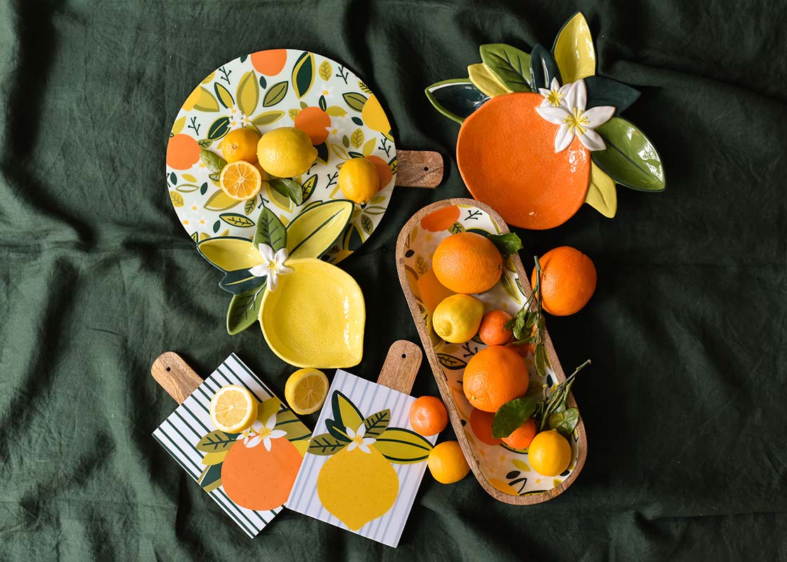 Overhead View of Blue Citrus Print Wood Medium Round Board and Coordinating Pieces from Citrus Collection