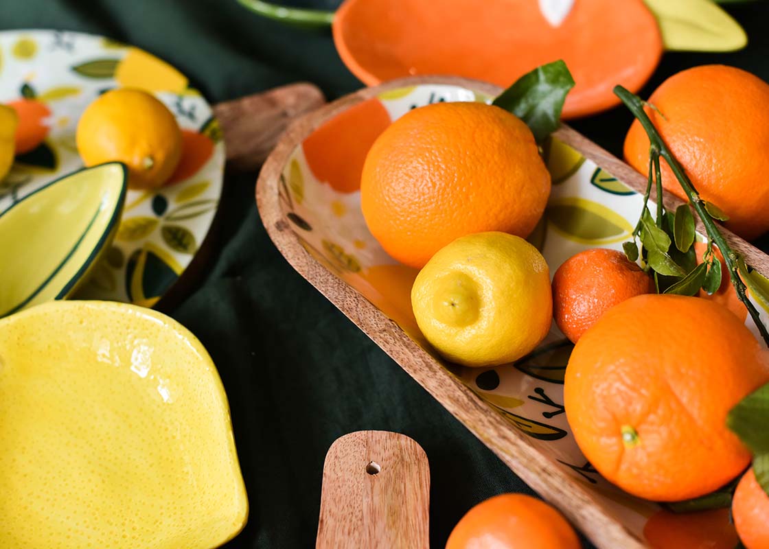 Cropped Close up of Oranges and Lemons in a Blue Citrus Print Wood Dough Bowl