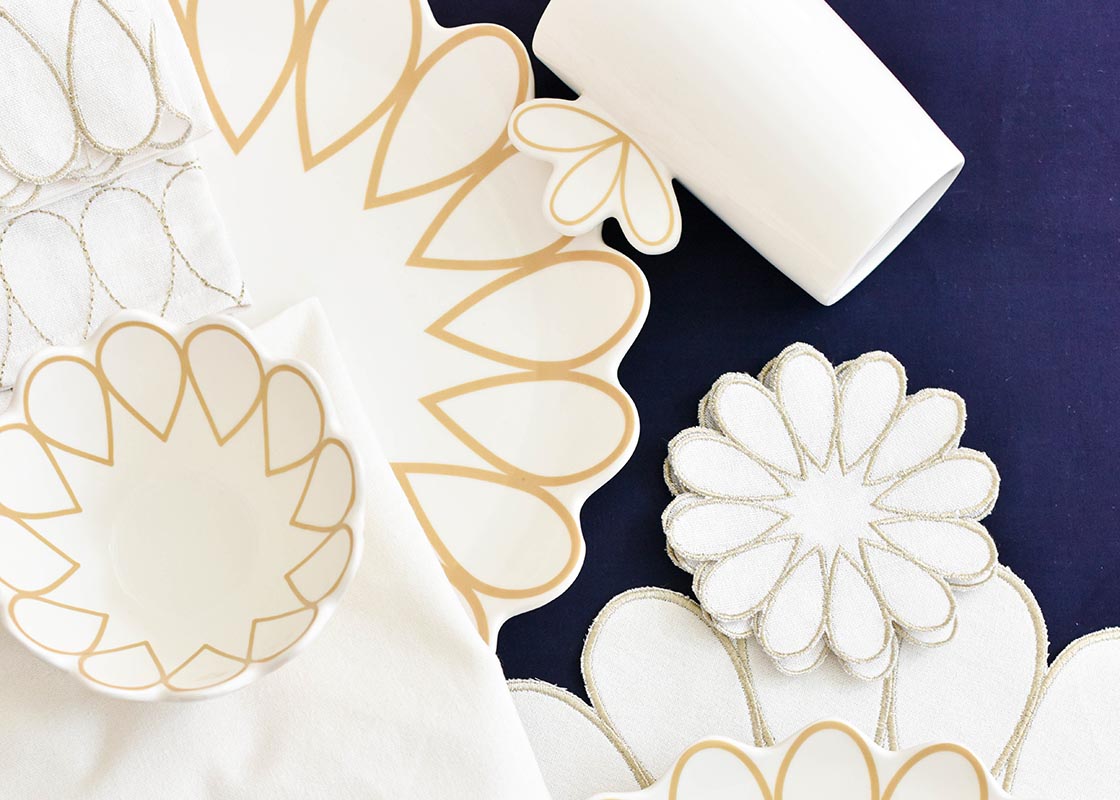 Overhead View of Coordinating Pieces from Deco Collection including Deco Gold Scallop Platter on Navy Backdrop