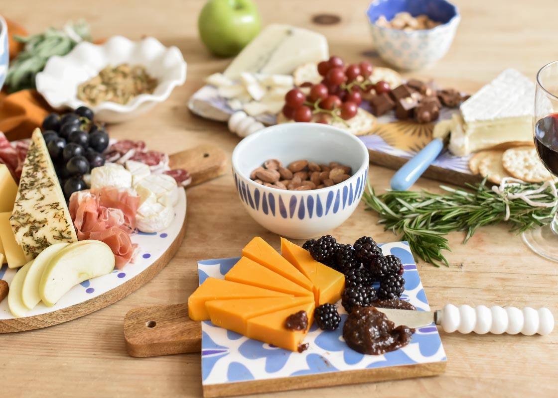 Front View of Charcuterie Spread on Coordinating Iris Blue Design Serveware Including Small Bowl