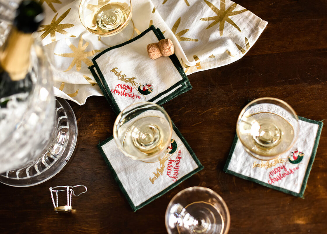 Overhead View of Wine Service Elevated with Linen Flying Santa Cocktail Napkins