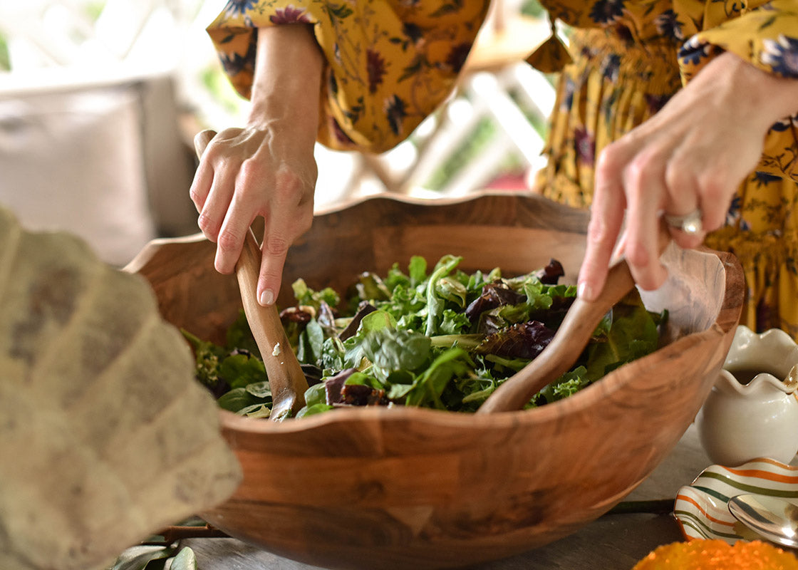 Close up of Woman Tossing Salad in Fundamental Wood 19in Ruffle Bowl