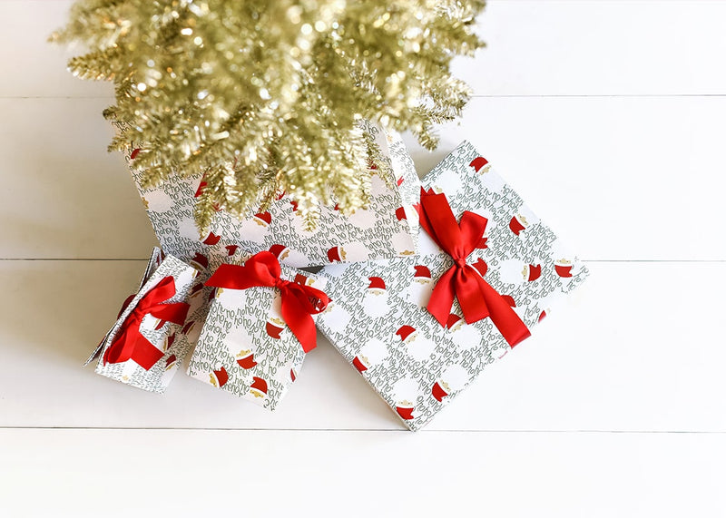 Ho Ho Santa Design Wrapping and Bags Under Gold Tinsel Tree