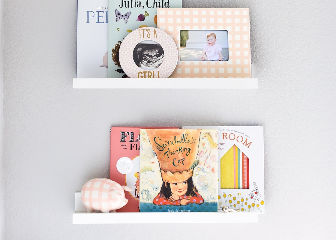 Front View of Home Decor on Shelving Including Pink Gingham Piggy Bank