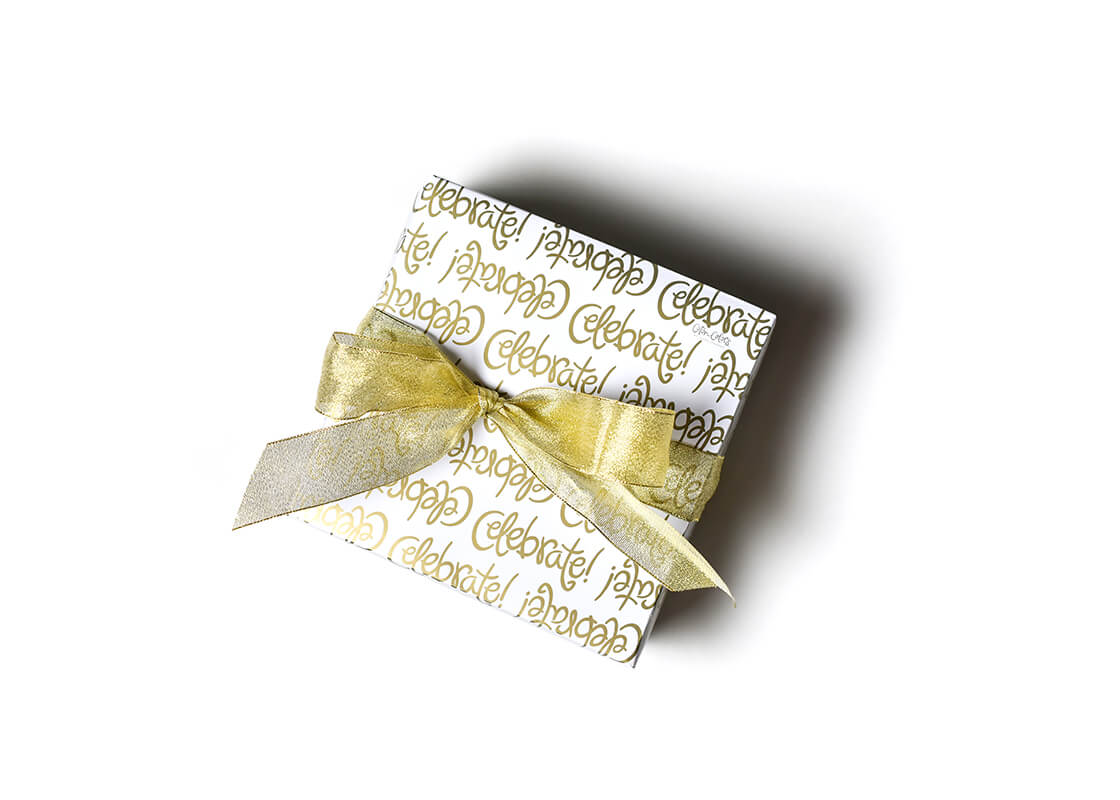 Overhead View of Gift with Gold Bow Wrapped in Celebrate Gift Wrapping Paper