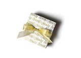 Gift with Gold Bow Wrapped in Celebrate Gift Wrapping Paper