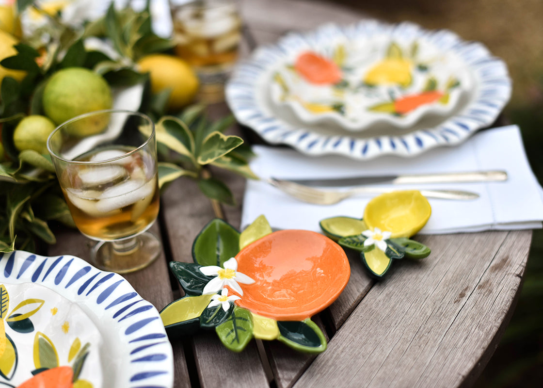 Front View of Orange and Lemon Dishes Coordinate with Citrus Designs on Tablescape