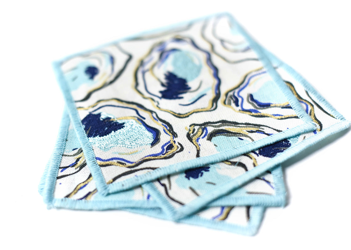 Close up of Embroidery on Loosely Stacked Oyster Print Cocktail Napkins Set of 4 Showing Pretty Fabric Texture