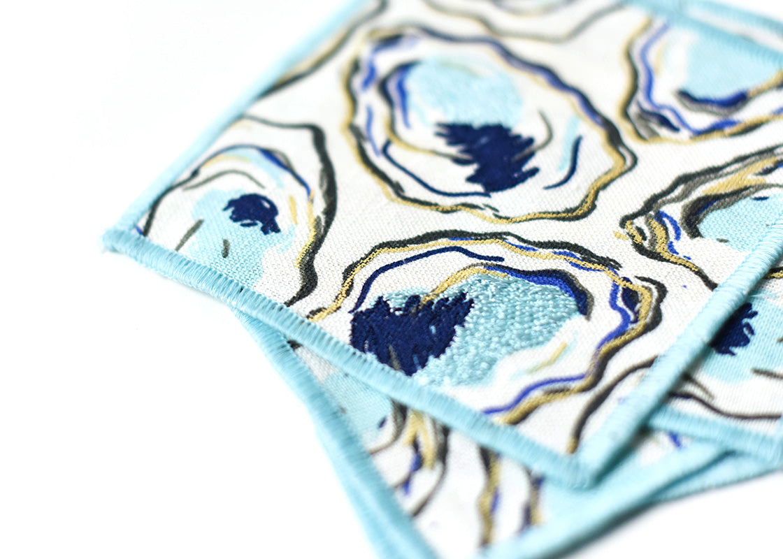Extreme Cropped Close up of Embroidery on Loosely Stacked Oyster Print Cocktail Napkins Set of 4 Showing Pretty Fabric Texture