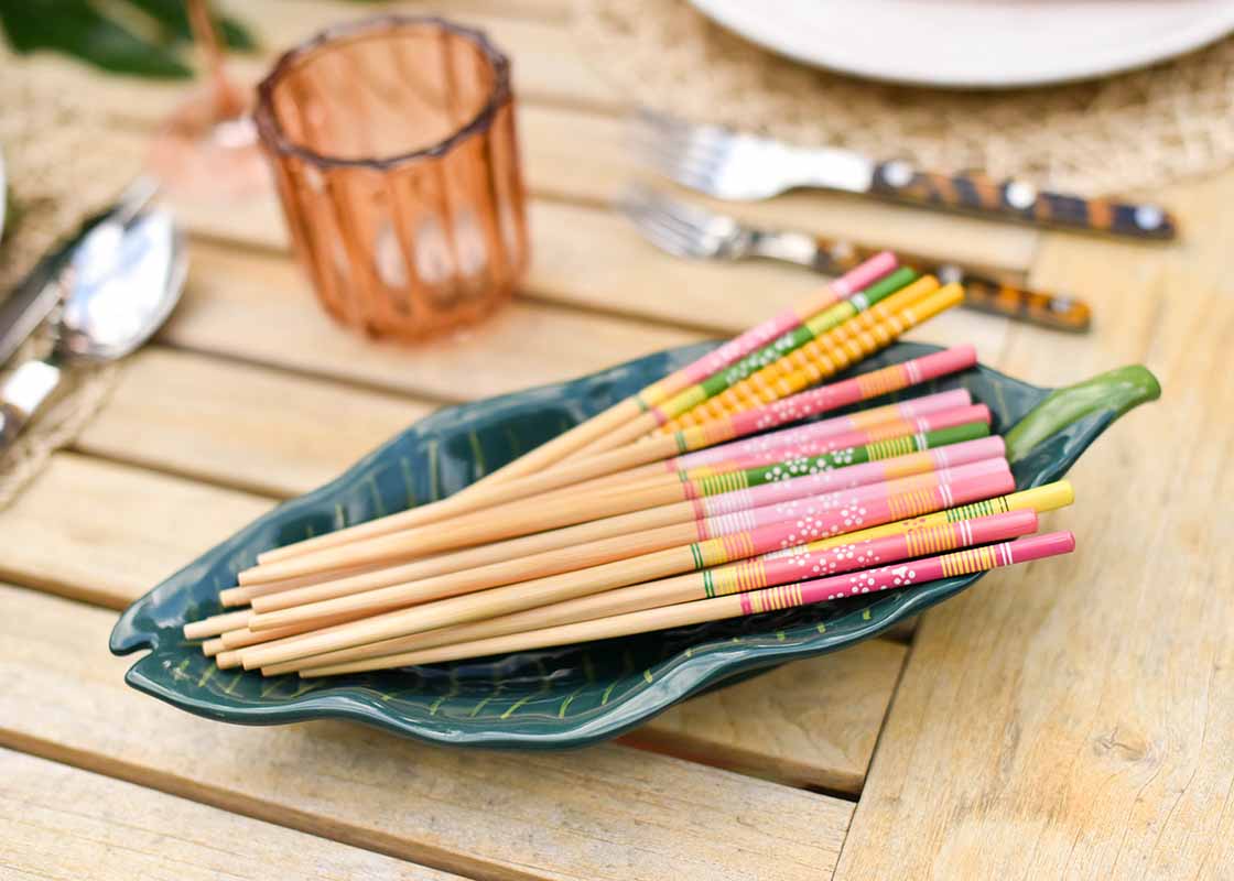 Front View of Palm Tray Holding Chopsticks on Tablescape