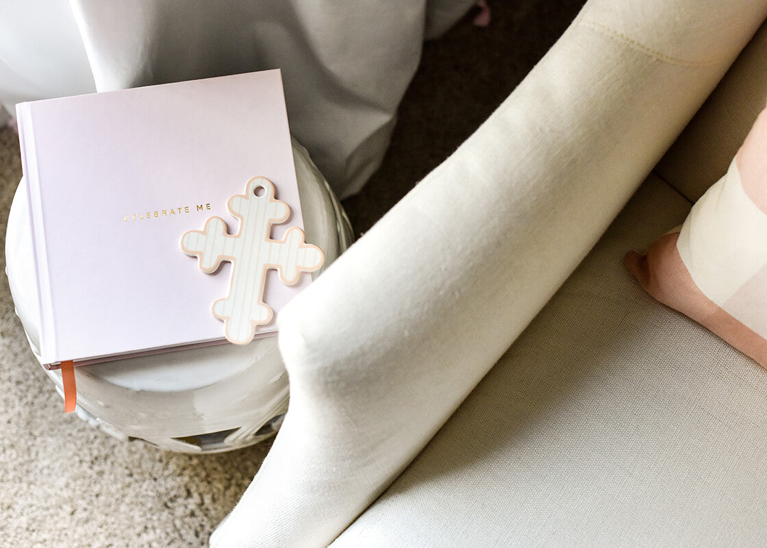 Overhead View of Pink Pinstripe 6” Cross Placed on Pink Celebrate Me Journal
