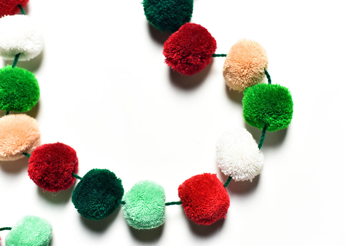 Cropped Close up of Colorful Pom Poms on Mint Multi Pom Pom Garland