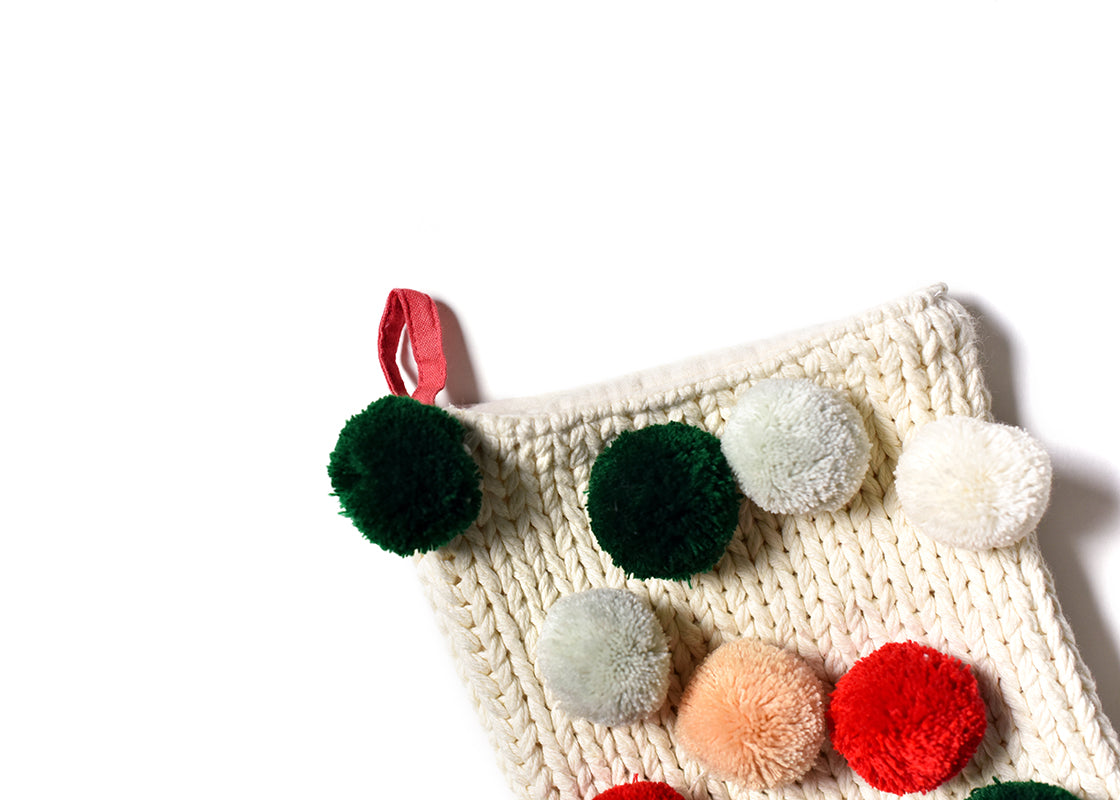 Cropped Close up of Loop Hanger and Colorful Pom Poms on Ecru Knit Stocking with Pom Poms