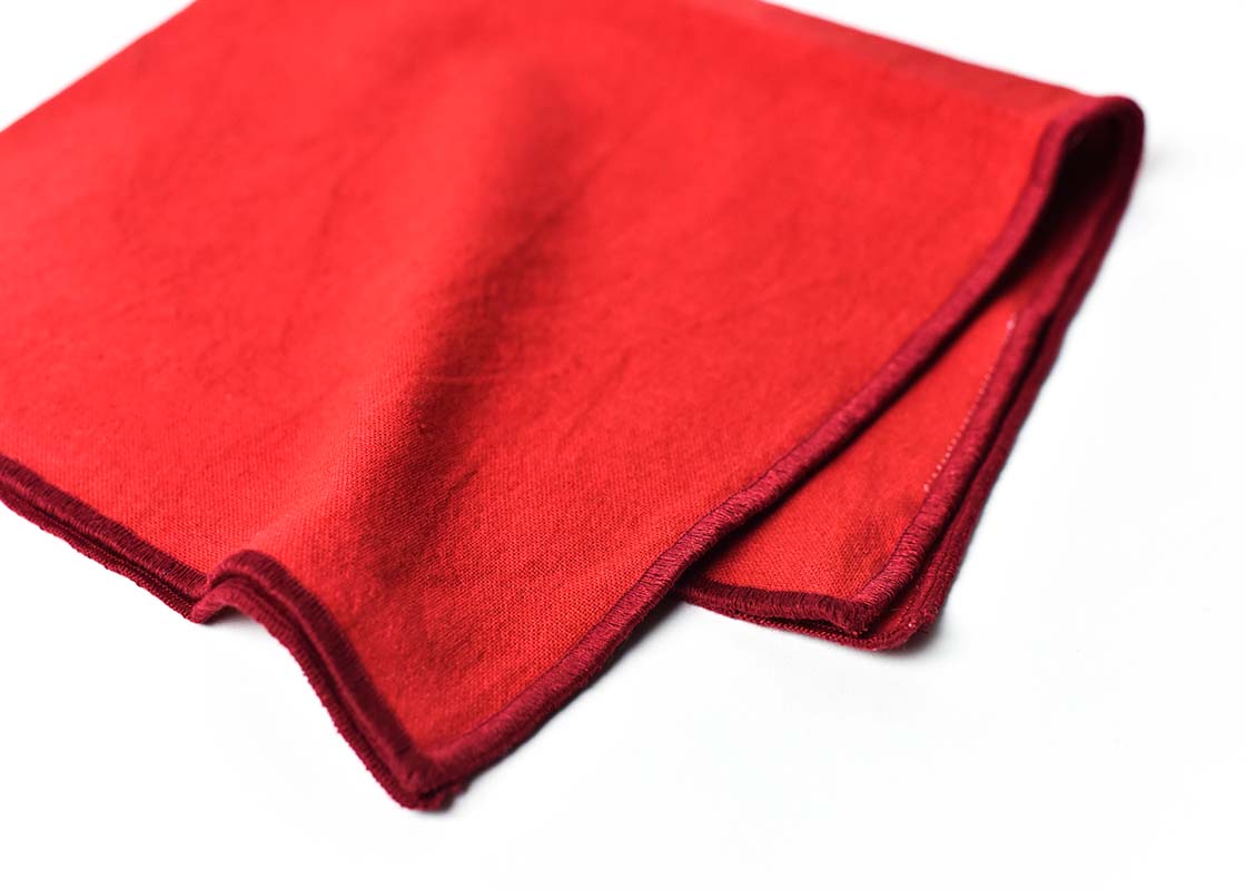 Cropped Close up of Red Stitched Edging on Folded Red Color Block Napkins Set of 4 Showcasing Beautiful Texture of Fabric