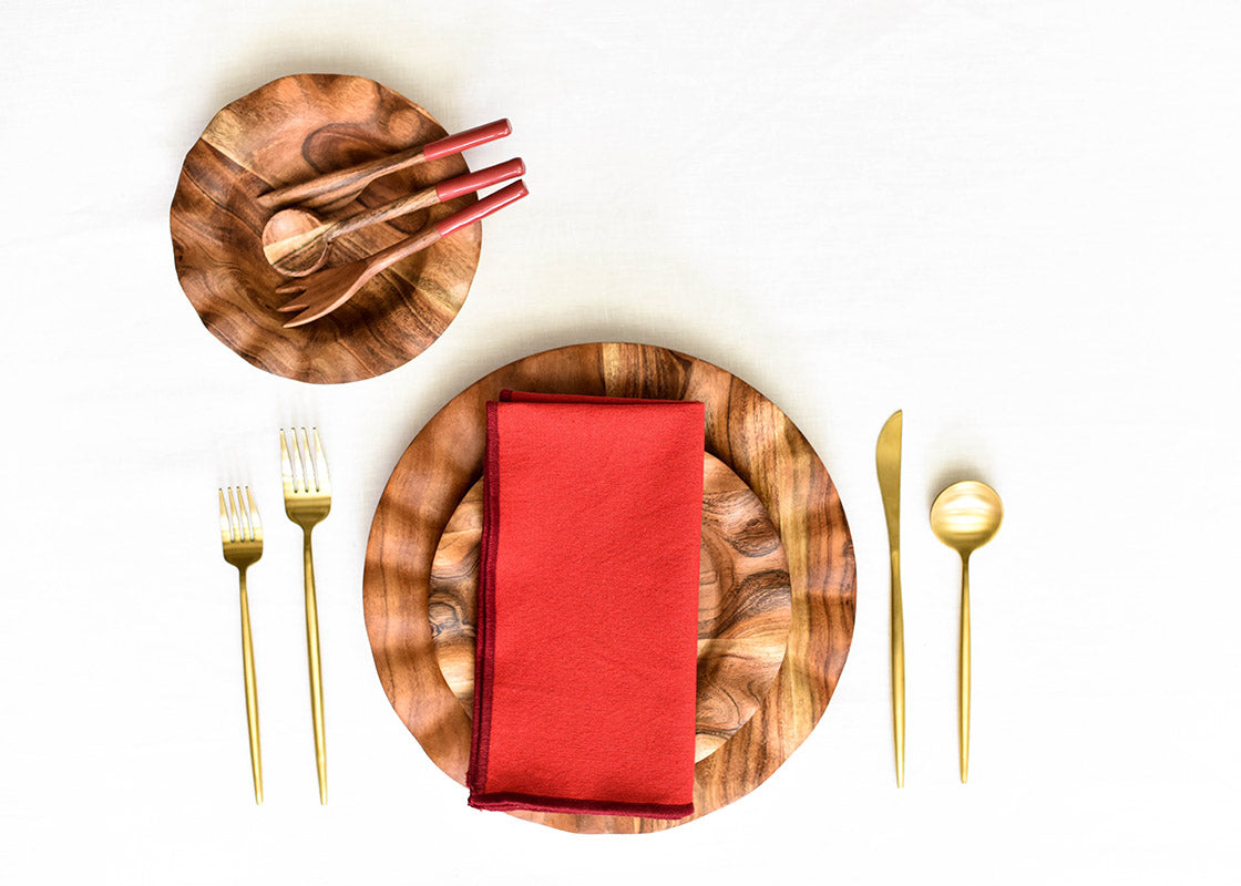 Overhead View of Fundamentals Wood Place Setting Coordinated with Red Color Block Napkin Placed on Top