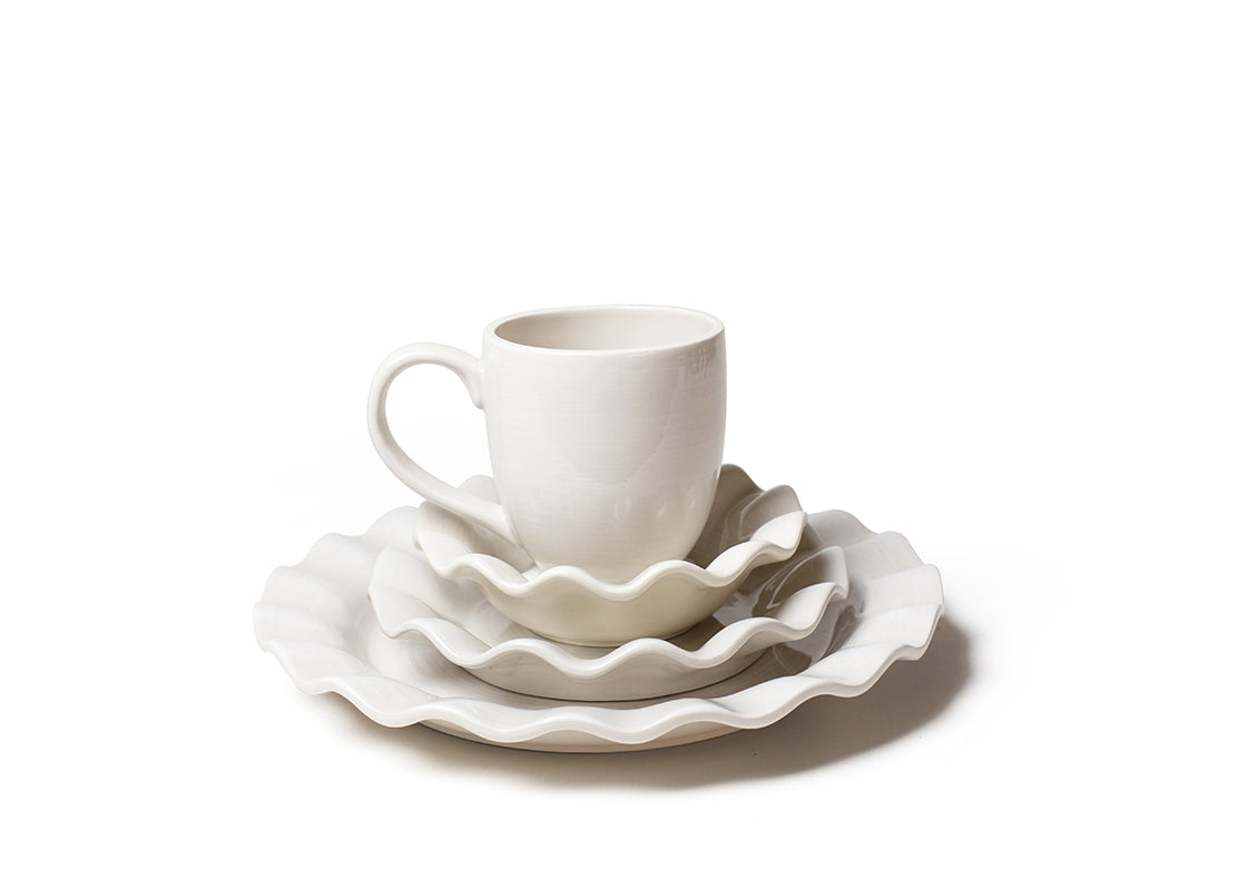 Front View of Neatly Stacked Signature White Ruffle 4 Piece Place Setting