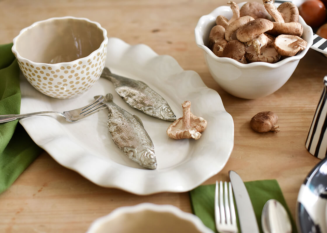 Cropped Close up of Coordinating Serveware Including Signature White Ruffle Bowl Filled with Ingredients