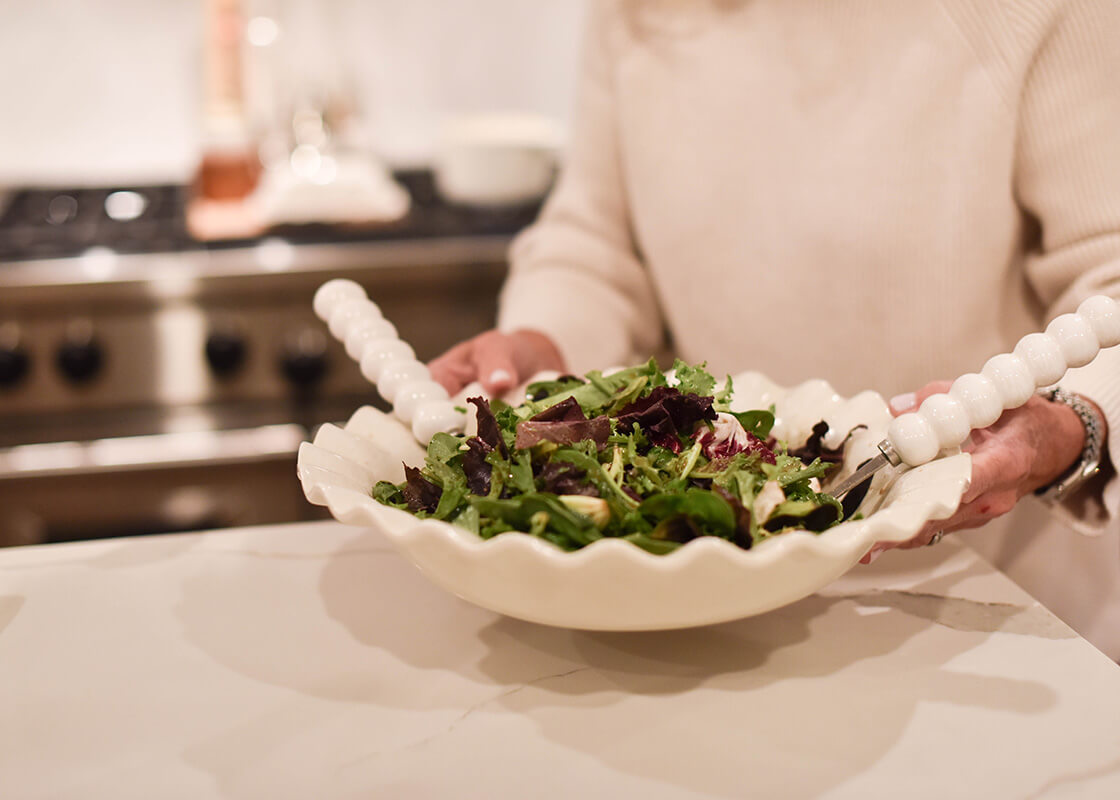 Front View of Woman Holding Signature White 13in Ruffle Best Bowl Filled with Salad