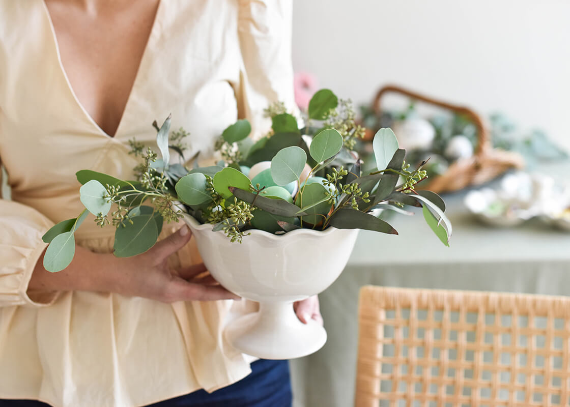 Front View of Woman Holding Signature White Ruffle Trifle Bowl with Eucalyptus Branches Showing Multi-Function