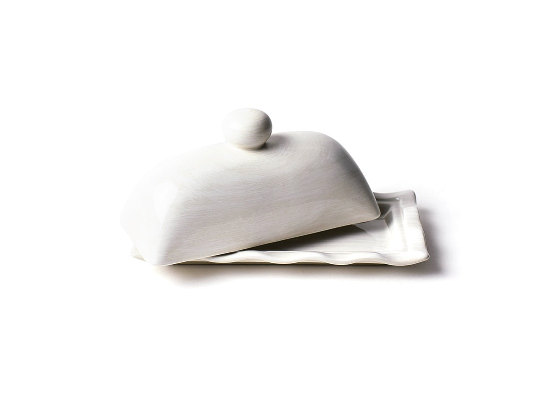 Front View of Domed Lid Slightly Ajar of Signature White Ruffle Domed Butter Dish Allowing a Peek of Tray