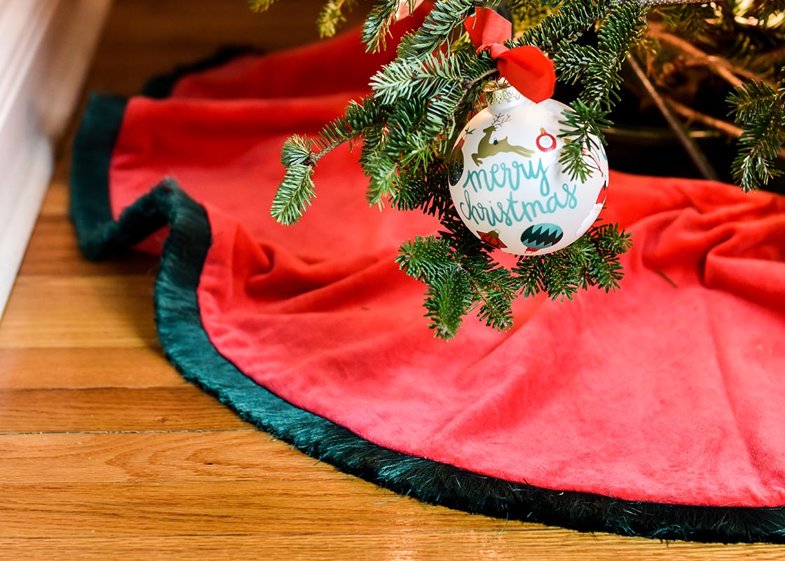 Front View of Red Velvet Skirt with Trim Under Christmas Tree