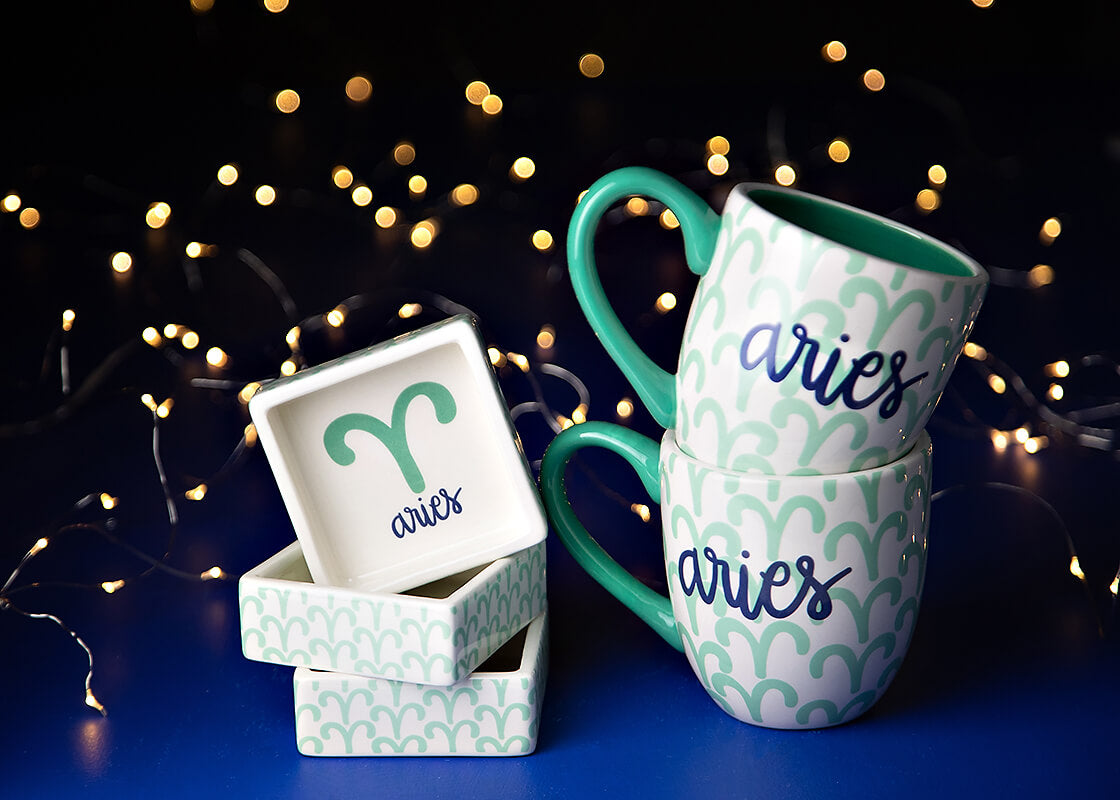 Front View of Stacked Zodiac Pieces Including Zodiac Aries Square Trinket Bowl with Coordinating Mugs