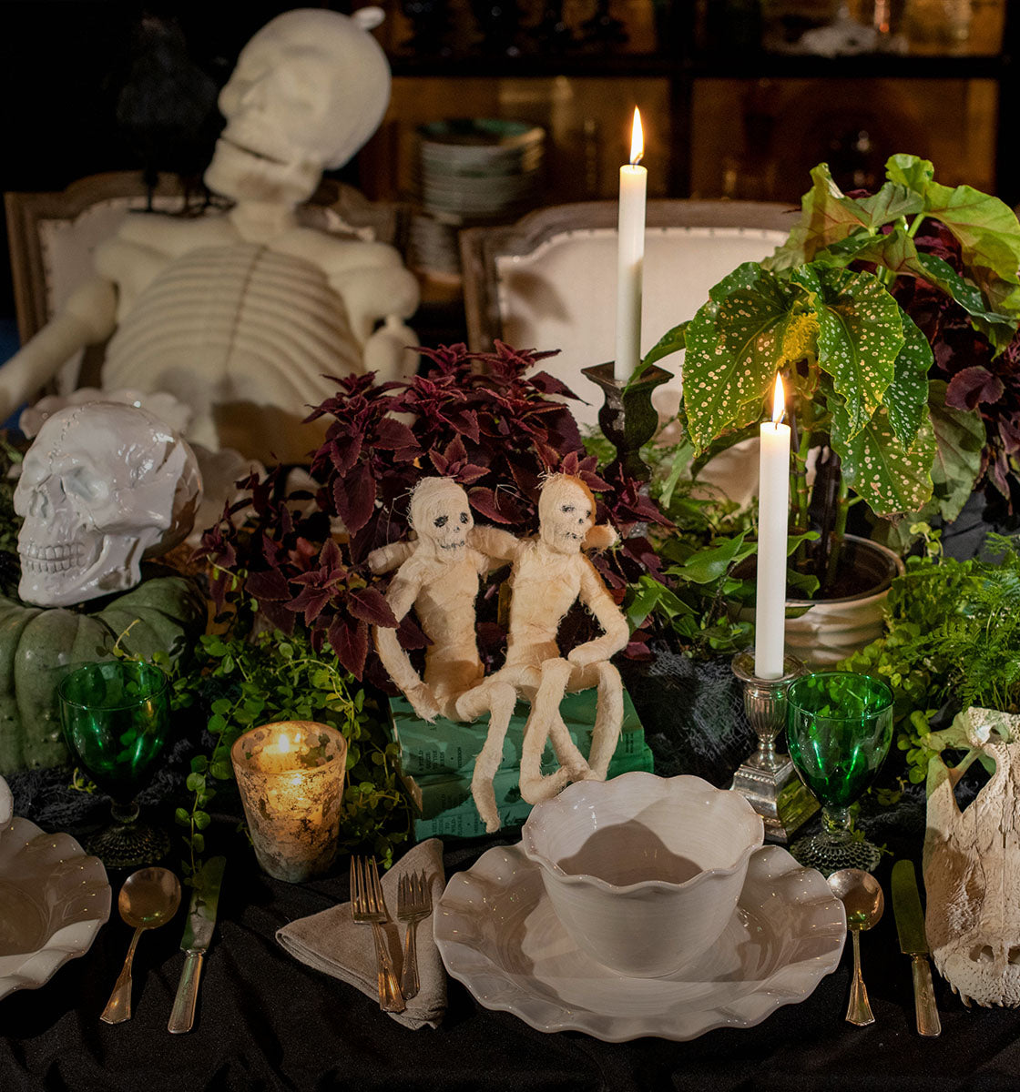 Cropped View of Clever Halloween Decor Used to Decorate a Spooky Tablescape  using Mixture of Signature White Ruffle Collection for Placesettings