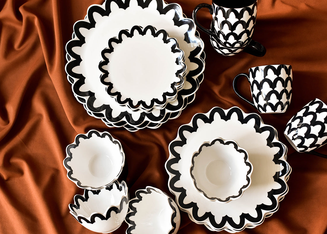 Overhead View of Crew Collection Including Black Arabesque Trim Scallop Dinner Plate