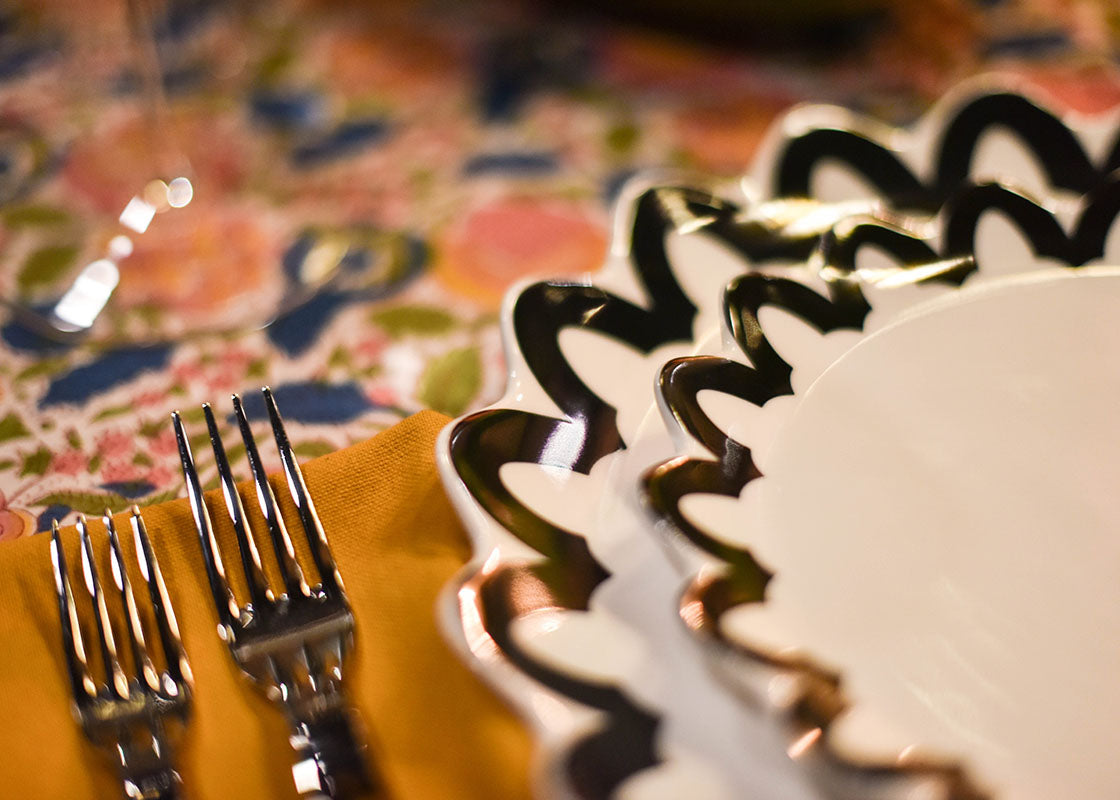 Extreme Cropped Close up of Individual Place Setting Including Black Arabesque Trim Scallop Dinner Plate