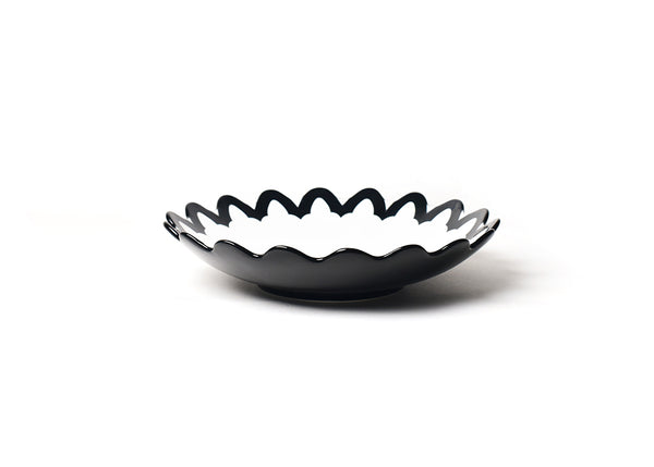 A black and white bowl with a bold arabesque pattern on the scalloped edge, ideal for serving signature dishes and enhancing your table decor.