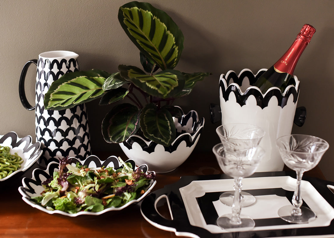 Front View of Stylish Buffet Table with Black Arabesque Scallop 9in Bowl and Other Serveware from Deco Collection