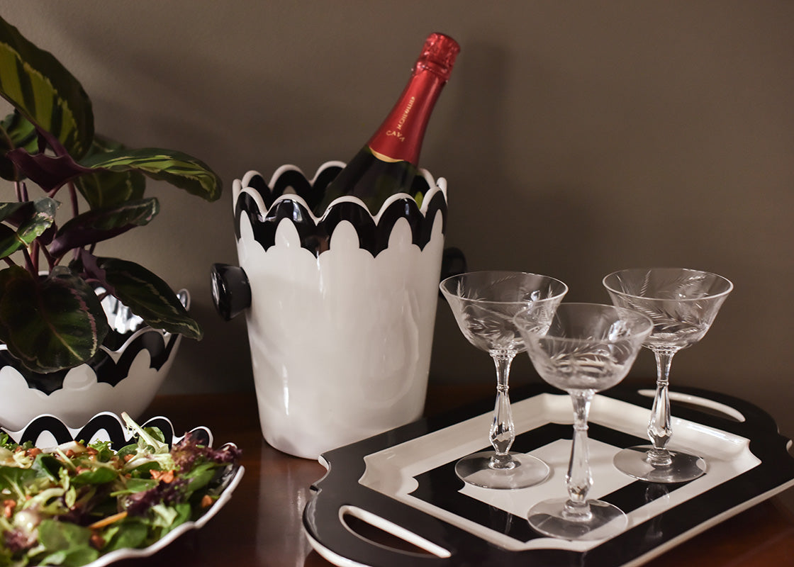 Front View of Black Arabesque Scallop Ice Bucket set on a Stylish Buffet